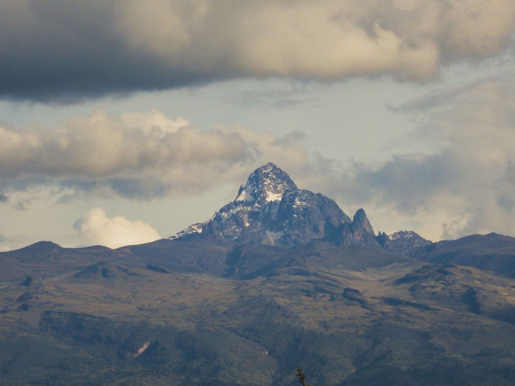 Snow-capped peaks of Mount Kenya rising above the highland moorland at dawn